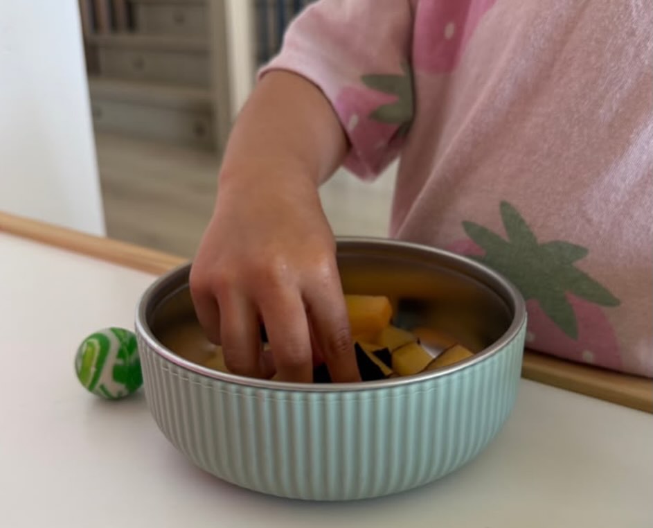 Toddler eating a snack from the BRAI + CO. toddler bowl